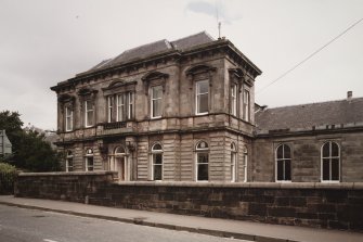View from WSW of W facade of office building at centre of Pilmuir 		Street frontage