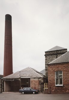 View from NE of boiler-house chimney, boiler house and former engine house, Victoria Works, Dunfermline.