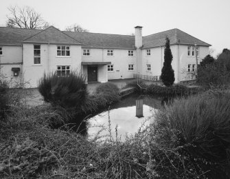 A block (FOSNI offices), view of entrance front (with pond in foreground)