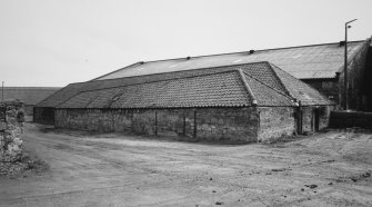 View of single storey warehouse with sloping roof ridge, from north west
