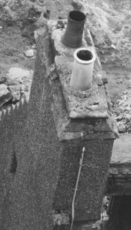 East gable chimney; view of moulded coping and finial base from above