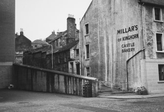 View from South of No.24 High Street (insc: 'Millar's of Kinghorn.  Castle Bakery') and Castle Wynd, including Joinery works.