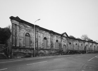 View from SSE of surviving facade of N part of works, also with M Nairn plaque