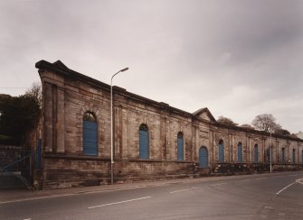 View from SSE of surviving facade of N part of works, also with M Nairn plaque