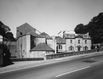 View from the South East showing the circular Horsemill, now Boiler house (left), wheat silos (behind left) and the main offices