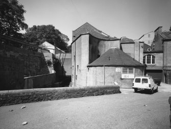 View from the South West of the circular horsemill, now the boilerhouse, wheat silos and the Burn