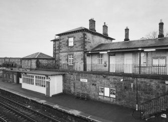 View of down platform with shelter and main station buildings from NE.