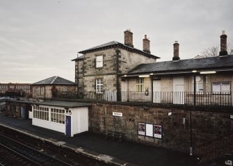 View of down platform with shelter and main station buildings from NE.