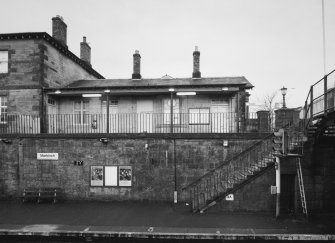 View across down platform to station buildings from E.