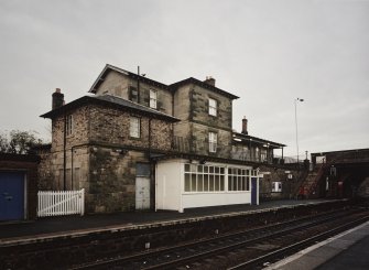 View across down platform to platform shelter and main station buildings from SE.