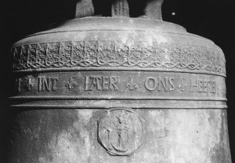 Belfry, bell, detail of inscription band and religious medallion