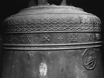 Belfry bell, detail of inscription band and religious medallion