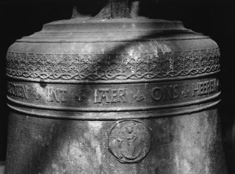 Belfry bell, detail of inscription band and religious medallion