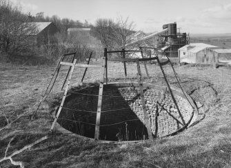 General view from ENE of lime works from top of old lime kiln, with mouth of pot in foreground