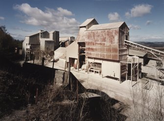 General view from SE of W end of lime works, which includes limestone milling departments containing ball mills, hopper stores, grading, bagging and conveying equipment