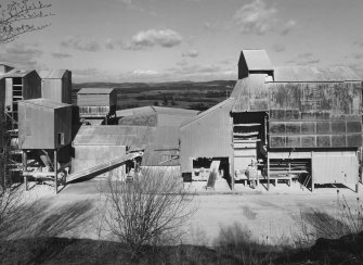 View from S of central section of lime works, which includes a hammer mill and conveying equipment