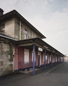 Detailed view from S along N-bound platform showing awning in front of station offices