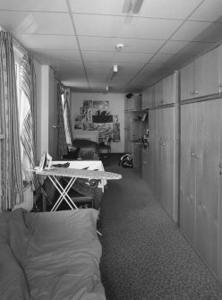 Interior view of 1935 Barrack Block showing first floor dormitory with beds and storage cupboards from N.