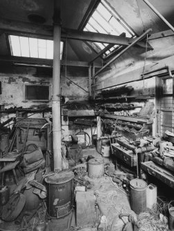 Interior of former smithy with forge in corner