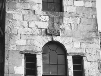 Steeple, north facade, datestone insc: '1808'.