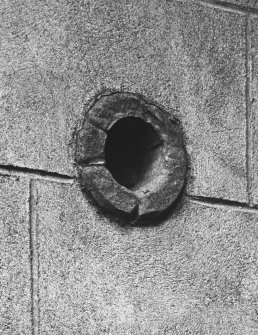 North front, east wing, exterior view of archaic pistol embrasure in re-entrant wall between level of ground-floor and first-floor