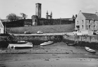 View of facing wall of quay on the shore, buildings at the South end of Shorehead and 
Cathedral and St Rule's in the distance.