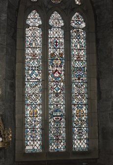 Interior. Detail of stained glass window in S wall