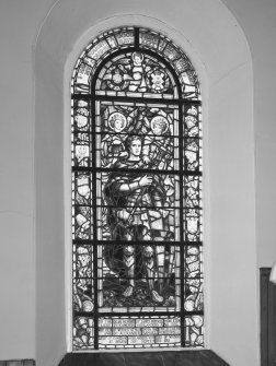View of large stained glass window to the left of the pulpit