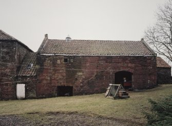 View from NE of N part of mill range, showing ramp leading to storage floor above cart bay (right), and former kiln (left) with small ventilator