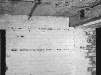 Interior.
Detail of brick wall with painted headings to record sortie details.