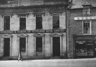 General view of Low Street, Banff, showing front of Clydesdale & North of Scotland Bank Limited and part of Rose's Temperance Hotel above Chas. C. Walker, Grocers.