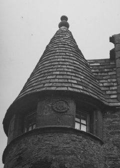 Fordyce Castle. View of angle-tower conical roof and panel over entrance.
