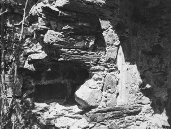 Interior.
Detail of remains of moulded arch in North-East angle of North wing on the first floor.