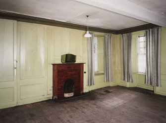 Interior.View of ground floor South room/ parlour from North showing the fireplace and panelling