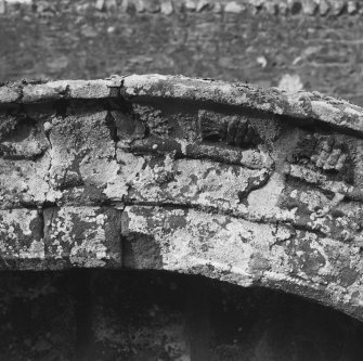 Churchyard, mural tomb, moulded filletted surround, decorative carved thistles, detail