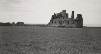 General view of castle and barmkin wall from South-East.