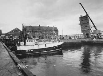 General view of South-West side of warehouse from South-West, across South Harbour.