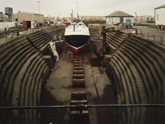 Peterhead, Union Street, North Harbour, Dry Dock
General view into dry dock, showing boat undergoing repairs.