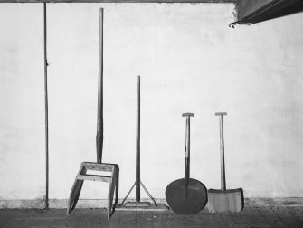 Aberdeen, Berryden Road, Millbank Mill, Corn Mill, Interior.
Detail of various implements used in grain drying kiln.
Pushing Implements. (left to right)
1st Two. for clearing grain off floor into discharge spouts.
3rd. possibly a cove shovel for kiln fuel.
4th. shovel for turning grain on drying floor.