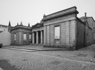 General view from SE showing central portico and advanced wings