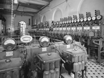 Interior. Upper level, detail of ampere dials with switchgear in background from S
