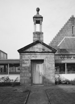 Entrance doorway and bellcote from 'Old Grammar School' now built into corridor linking main building to extensions at rear. View from E