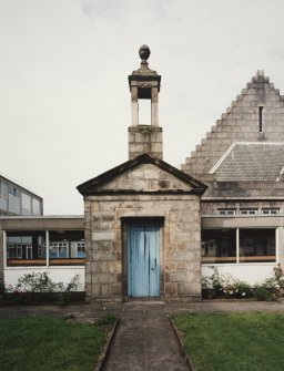 Entrance doorway and bellcote from 'Old Grammar School' now built into corridor linking main building to extensions at rear. View from E