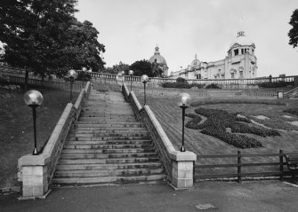 View of North access steps and decorative flowerbeds from South