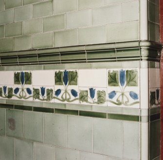 Interior. Detail of typical green wall tiles, including dado and band of ornate tiling