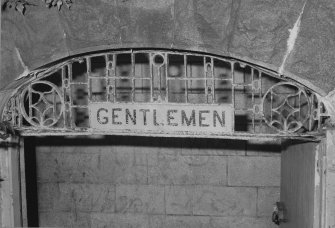 Interior. Detail of the entrance sign and ironwork situated above the main door to the toilets