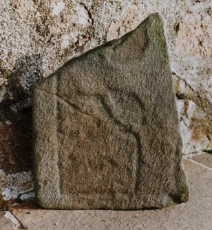 Carved stone with trefoil leaf pattern.