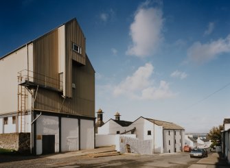 Bowmore Distillery
Oblique view from SW along SE side of distillery, overlooking School Street, with working floor maltings in middle distance, and grain store in foreground