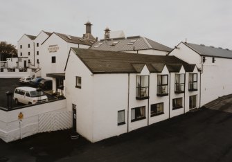 Bowmore Distillery
Elevated view from NNE showing visitors' centre and offices (foregroud), with the maltings and kilns in the background
