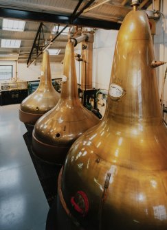 Bowmore Distillery
Interior view within still house showing three of the four copper pot stills, all of which are heated by steam coils